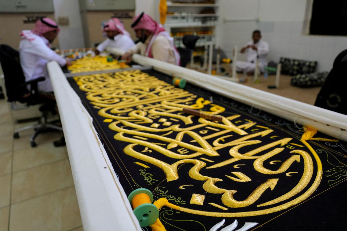 Workers prepare the Kiswa, a silk cloth that covers the Kaaba, the sacred building at the centre of the Grand Mosque, ahead of the annual hajj pilgrimage, at a factory in the holy city of Mecca, Saudi Arabia