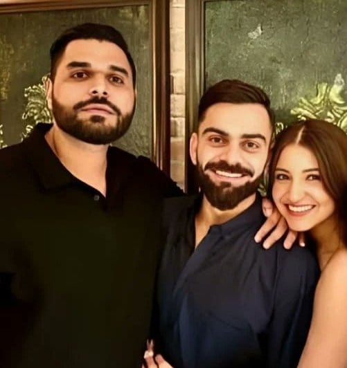An undated photograph of Nikhil Sosale with Virat Kohli and Anushka Sharma.
