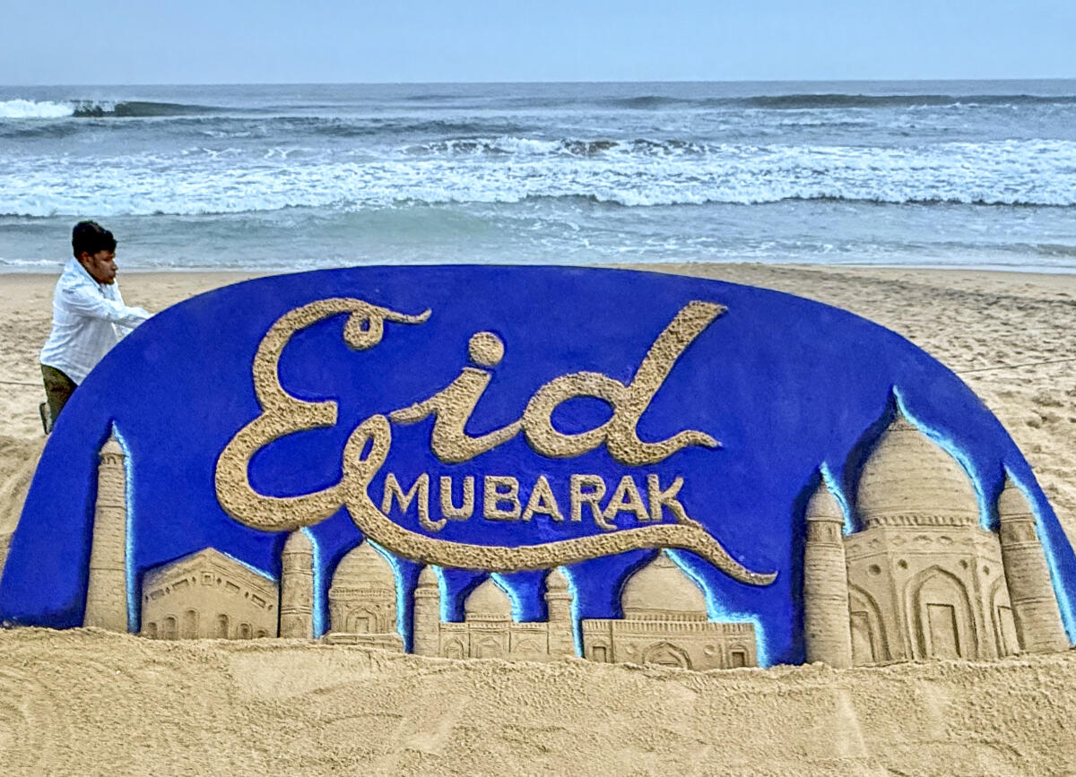 Sand artist Sudarsan Pattnaik makes a sand sculpture on the eve of Eid al-Adha, at Puri beach, in Odisha
