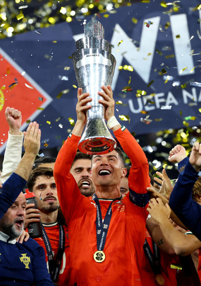 Portugal's Cristiano Ronaldo lifts the trophy as he celebrates with teammates after winning the Nations League.