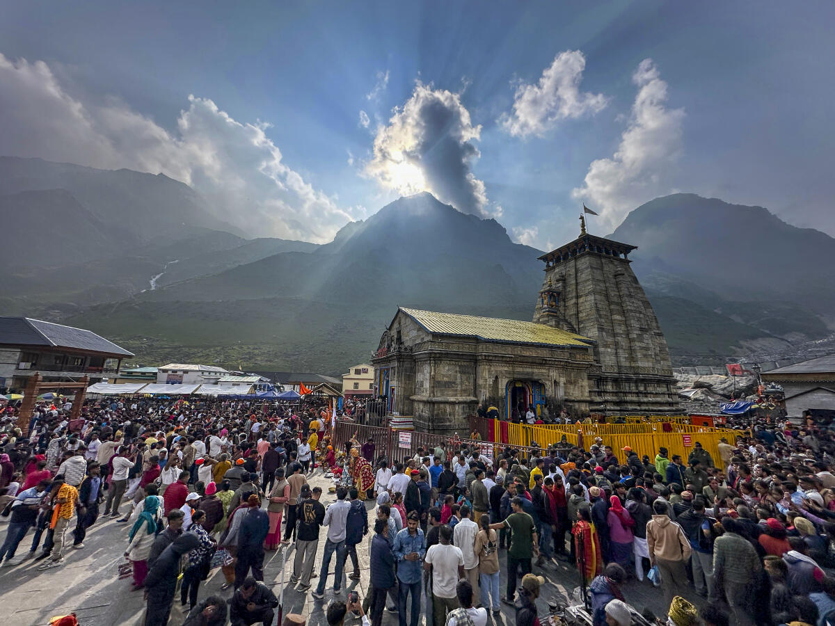 Devotees wait to offer prayers at the Kedarnath temple, in Rudraprayag district of Uttarakhand, Monday, June 9, 2025.