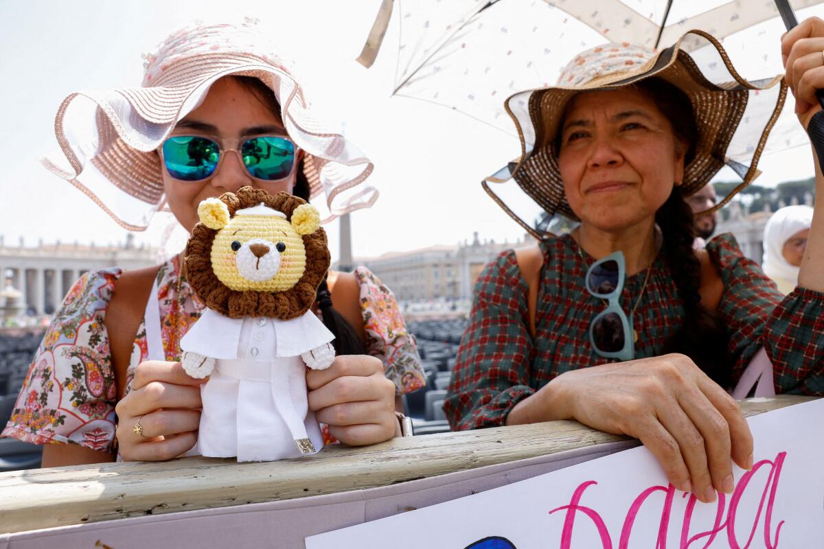 A faithful holds a toy lion wearing papal clothing, on the day of Pope Leo XIV's general audience in St. Peter's Square, at the Vatican June 11, 2025.