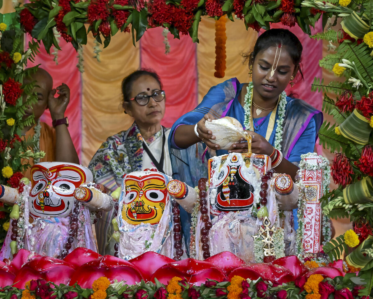 A priest performs 'Purnima Snan', a sacred bath ritual of Lord Jagannath, Lord Balabhadra and Goddess Subhadra, in Nadia, West Bengal, Wednesday, June 11, 2025. The ceremonial bathing is known as Snana Yatra.