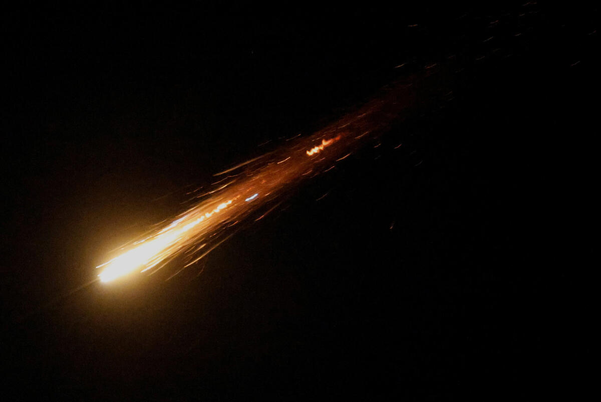 A missile launched from Iran is seen from the city of Ashkelon, Israel, June 13, 2025.
