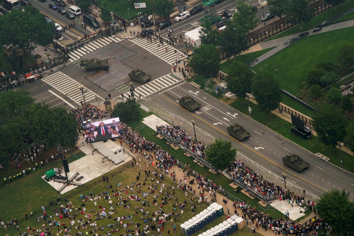 Armoured vehicles move on a road as people watch during a military parade to commemorate the U.S. Army's 250th Birthday in Washington, DC, US, June 14, 2025. 