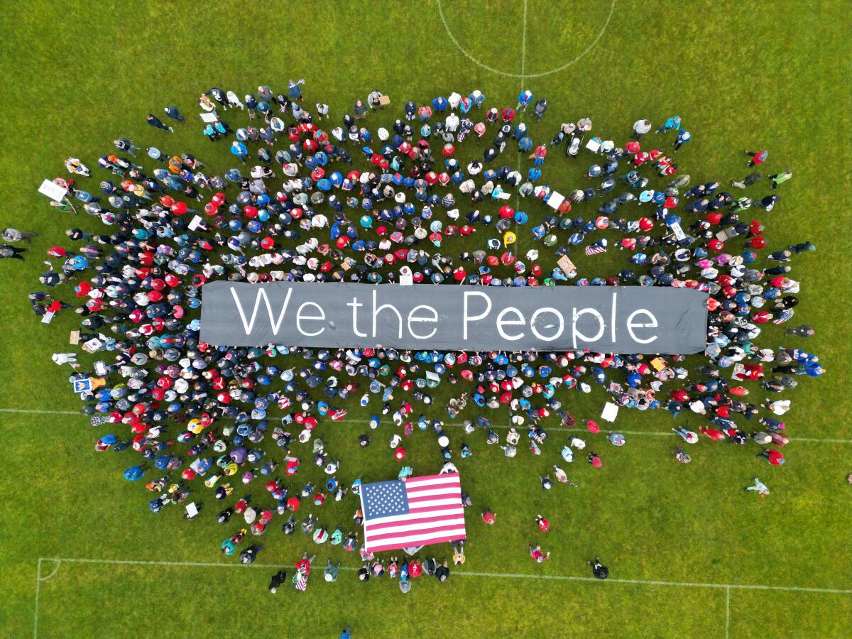 A drone view shows protesters holding a "We the people" sign during a No Kings Day protest against Trump's policies, in Bennington County, Vermont, US, in this handout photo released June 14, 2025.