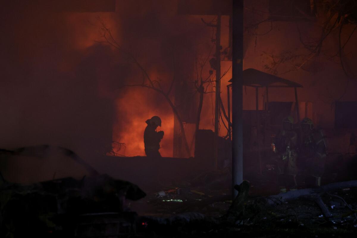 Firefighters work at an impact site following a missile attack from Iran on Tel Aviv, Israel, June 16, 2025.