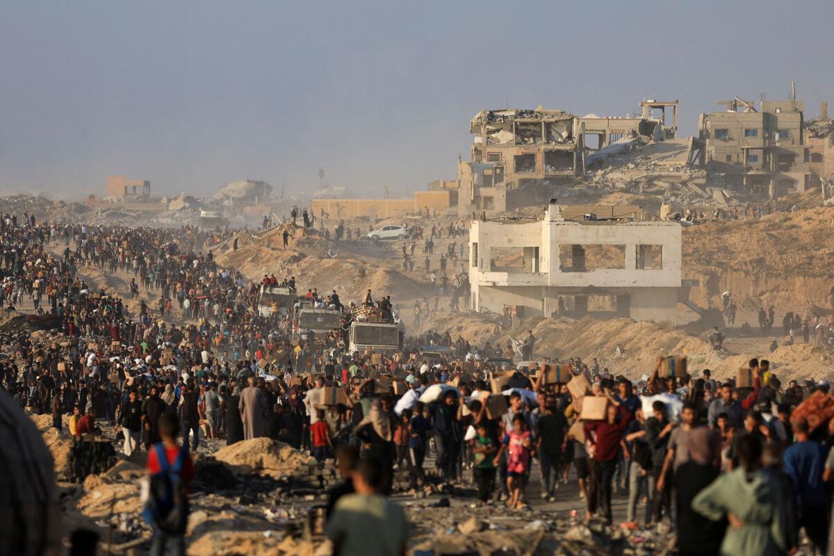 Palestinians gather to receive aid supplies in Beit Lahia, in the northern Gaza Strip, June 16, 2025. 