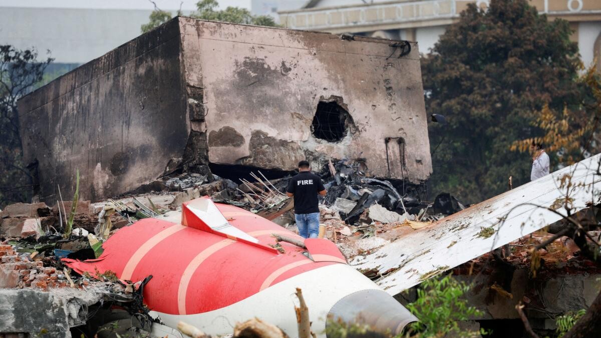 A fire officer stands next to the crashed Air India Boeing 787-8 Dreamliner aircraft, in Ahmedabad