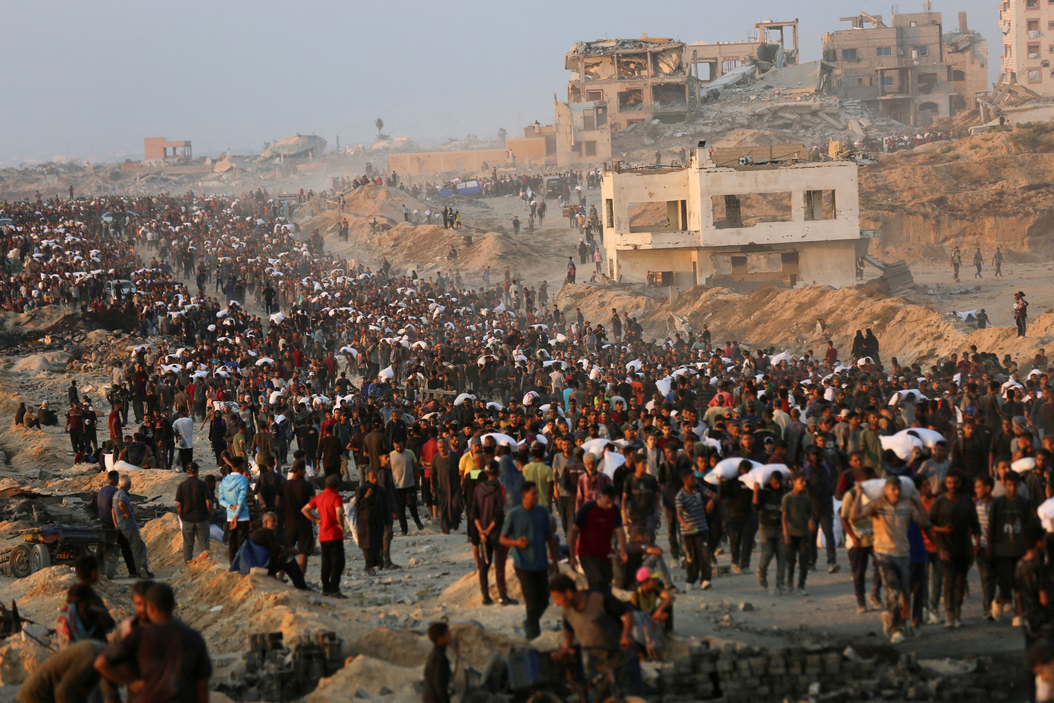 Palestinians gather to receive aid supplies in Beit Lahia, in the northern Gaza Strip, June 17, 2025.