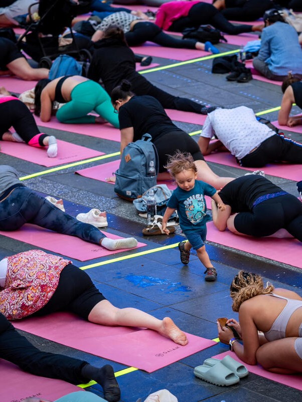 People practise yoga in large numbers at Times Square in New York. 