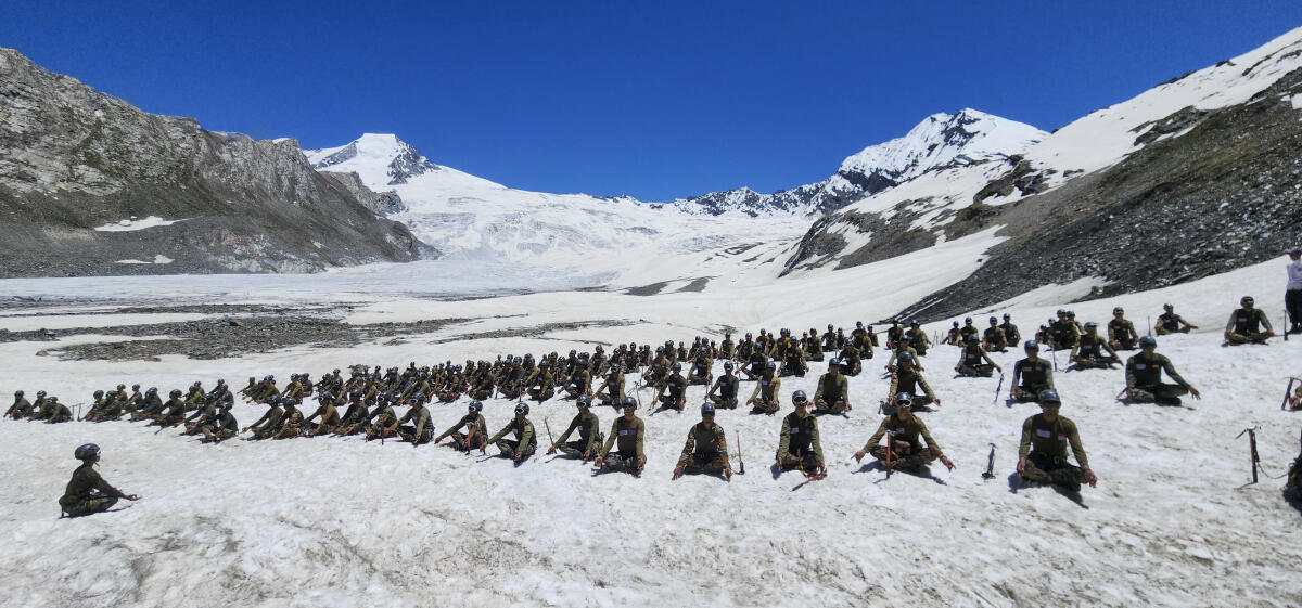 In this image, Indian Army personnel perform yoga on the occasion of the International Day of Yoga. 
