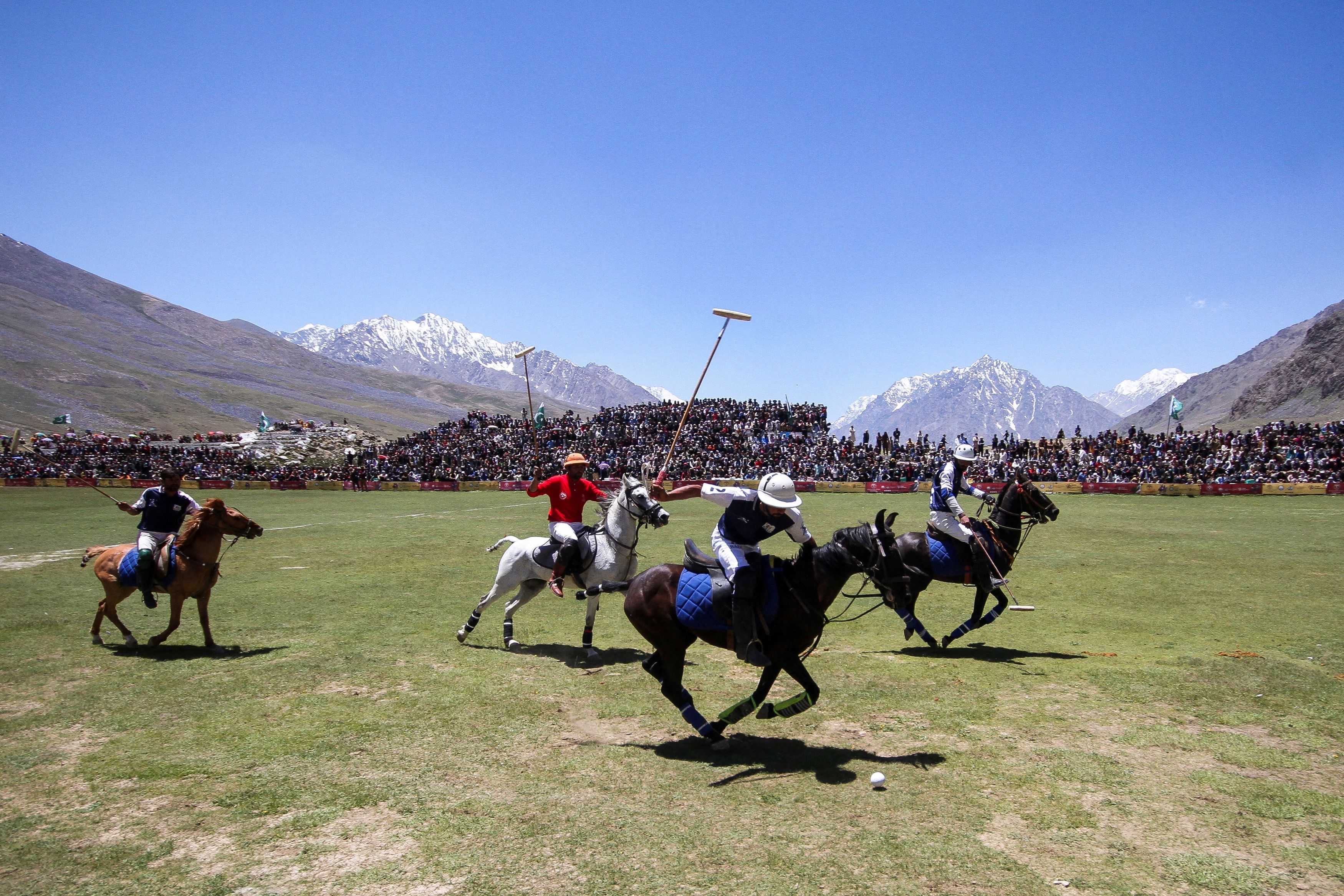 Players (Gilgit-Baltistan in Blue and Chitral Laspur in Red) fight for the ball during the annual Shandur Polo Festival, at Shandur Pass, at an estimated altitude of around 3700 meters, in Chitral, Pakistan June 20, 2025.
