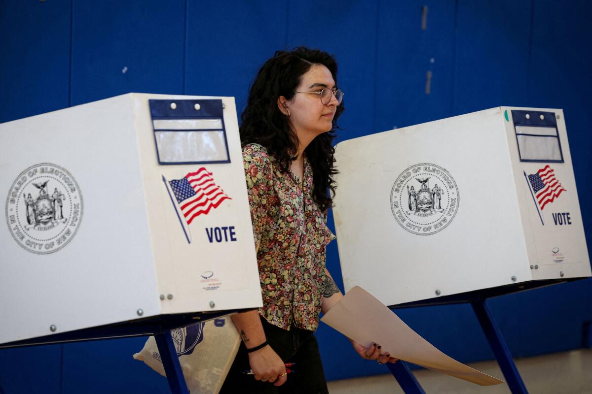 A woman votes in the primary election, which includes the race for the Democratic candidate for New York City mayor in the November's election, in the Brooklyn borough of New York City