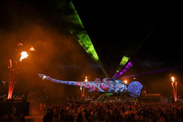 The Arcadia Dragonfly lights up at the Glastonbury Festival, marking the launch of Build the Peace, a new initiative transforming military machines into unifying art across post-conflict zones, in Somerset