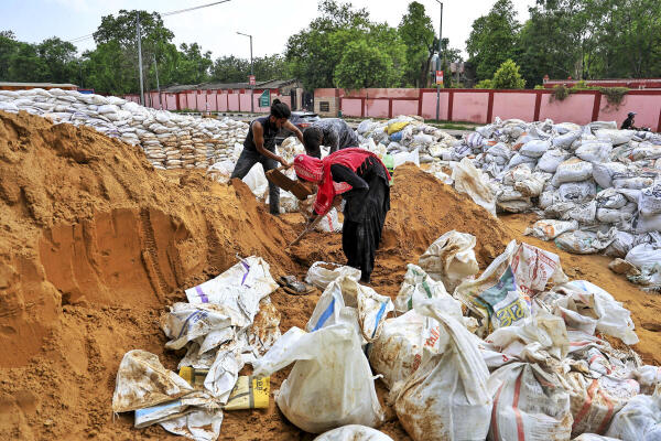 Workers prepare sandbags as a precautionary measure against heavy rainfall amid monsoon season, in Jaipur