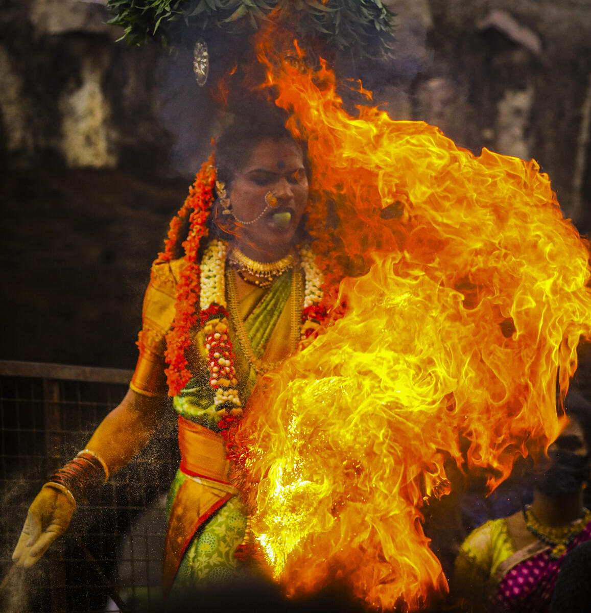 A ‘Shiva Shakthi’ woman carrying ‘Bonam’ proceeds towards Sri Jagadamba Mahakali temple during the ‘Ashada Masam Bonalu’ festival celebration, at the Golconda Fort