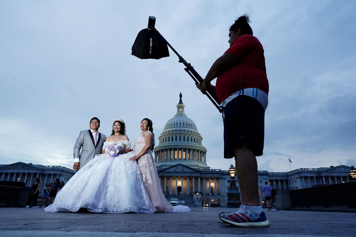 Diana Galindo Rodriguez, a bride to be, and her parents Limber Galindo and Nilda Rodriguez pose for a photo in front of the Capitol, in Washington