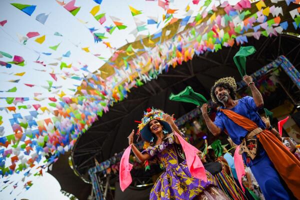 Members of the stilt-walking group Quadrilha de Gigantes perform during the traditional "Festa Junina" celebration at the Feira de Sao Cristovao in Rio de Janeiro, Brazil