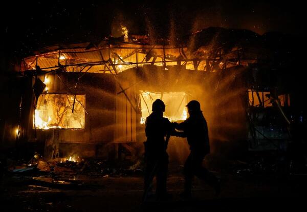 Firefighters work to put out a fire at the market hit by recent shelling, which local Russian-installed authorities called a Ukrainian military strike, in the course of Russia-Ukraine conflict in Donetsk