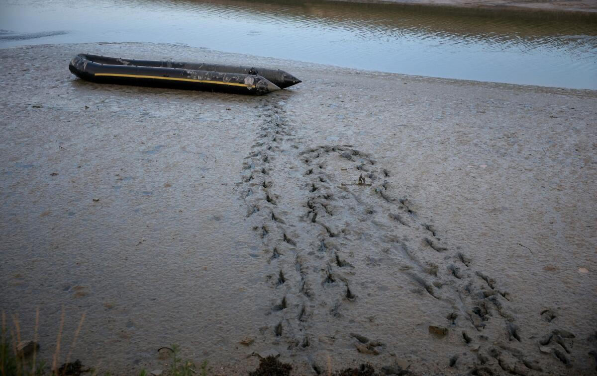 Footprints lead away from an abandoned inflatable migrant boat near Gravelines, France, July 10, 2025.