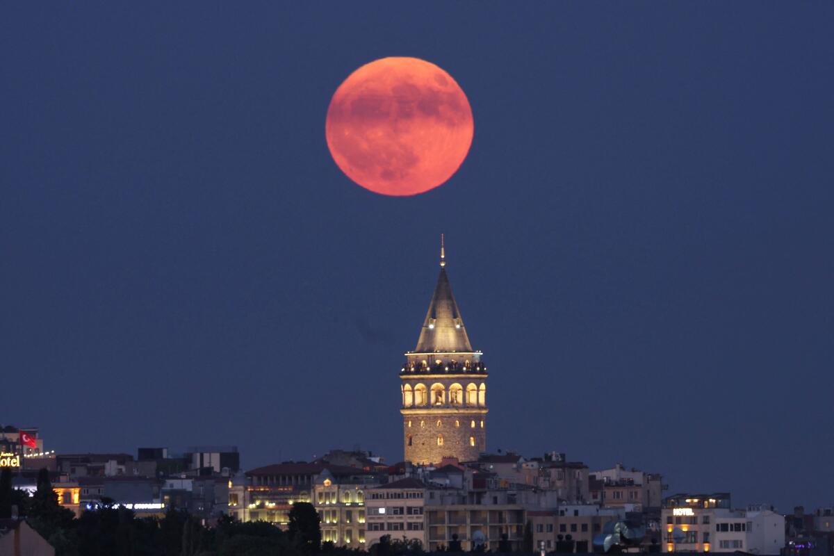A full moon, known as the Buck Moon, rises over the Galata Tower in Istanbul, Turkey, July 10, 2025.