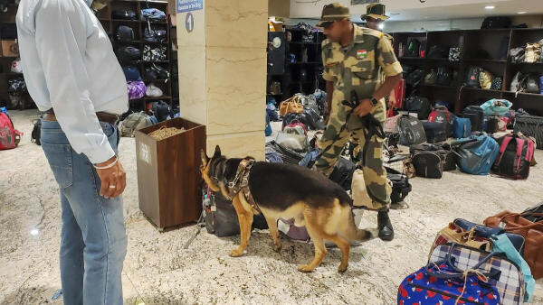 A BSF personnel along with dog squad checks the premises of the Golden Temple after it received a second bomb threat within 24 hours, in Amritsar.