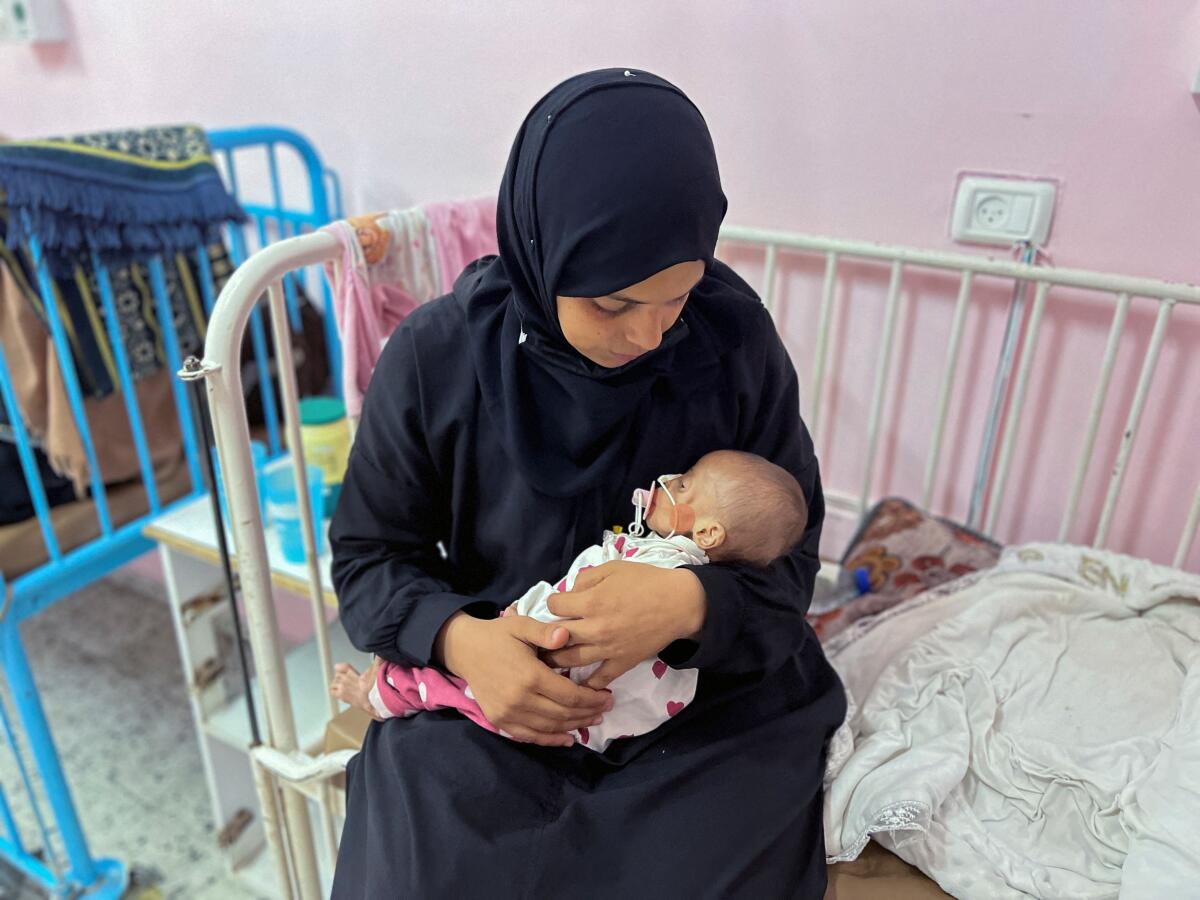 Palestinian mother Israa Abu Haleeb looks after her five-month-old daughter, Zainab, who is diagnosed with malnutrition, according to medics, at Nasser hospital in Khan Younis, in the southern Gaza Strip.