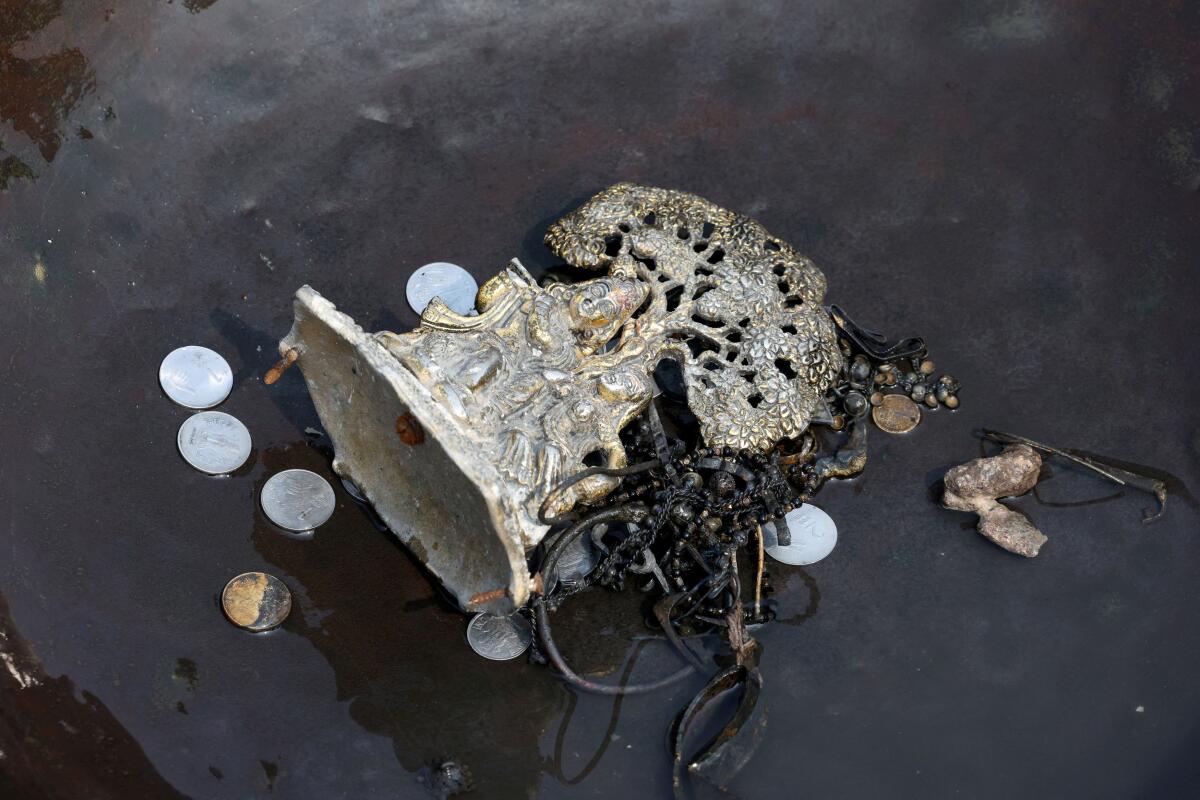 Items collected by people, who go to the river to hunt for coins and other valuables from the waters of river Yamuna, are kept in a container in New Delhi.