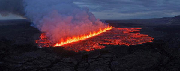 Lava emerges through a fissure following a volcano eruption near Grindavik, Reykjanes, Iceland.