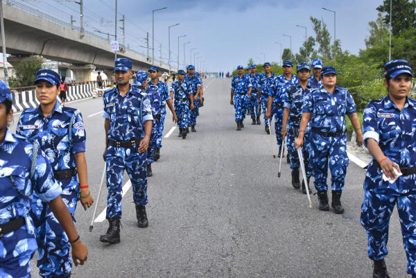 Rapid Action Force personnel conduct patrolling on the Kanwar Yatra route, in Meerut.