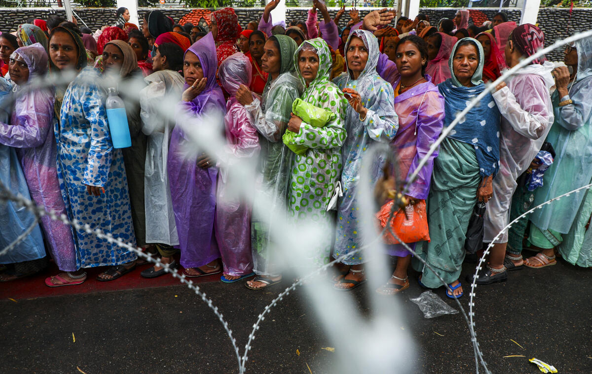 Pilgrims wait in queues for their registration for the annual Amarnath Yatra, outside Saraswati Dham in Jammu.