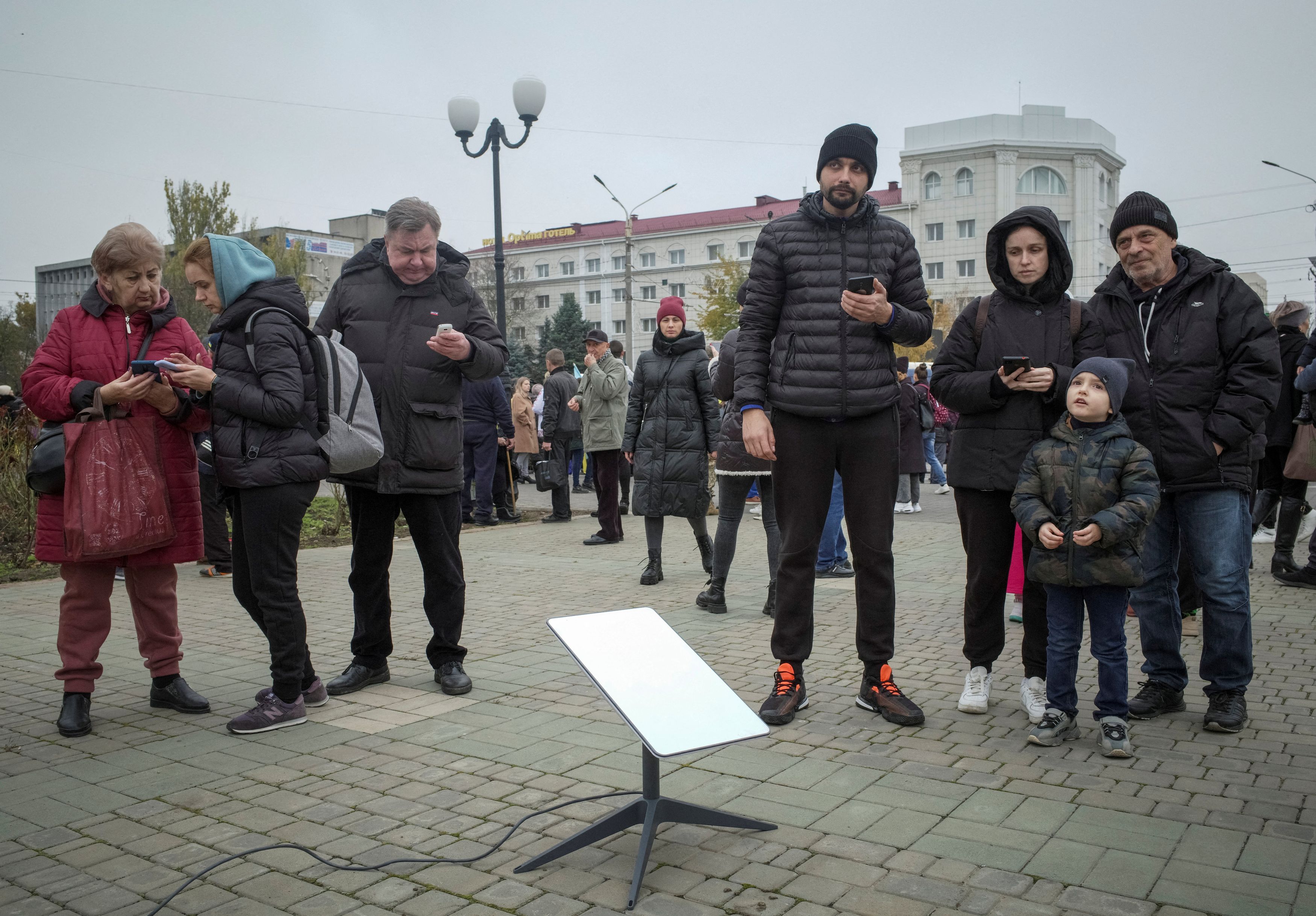 FILE PHOTO: Local residents use a Starlink terminal after Russia's retreat from Kherson, in central Kherson, Ukraine November 12, 2022