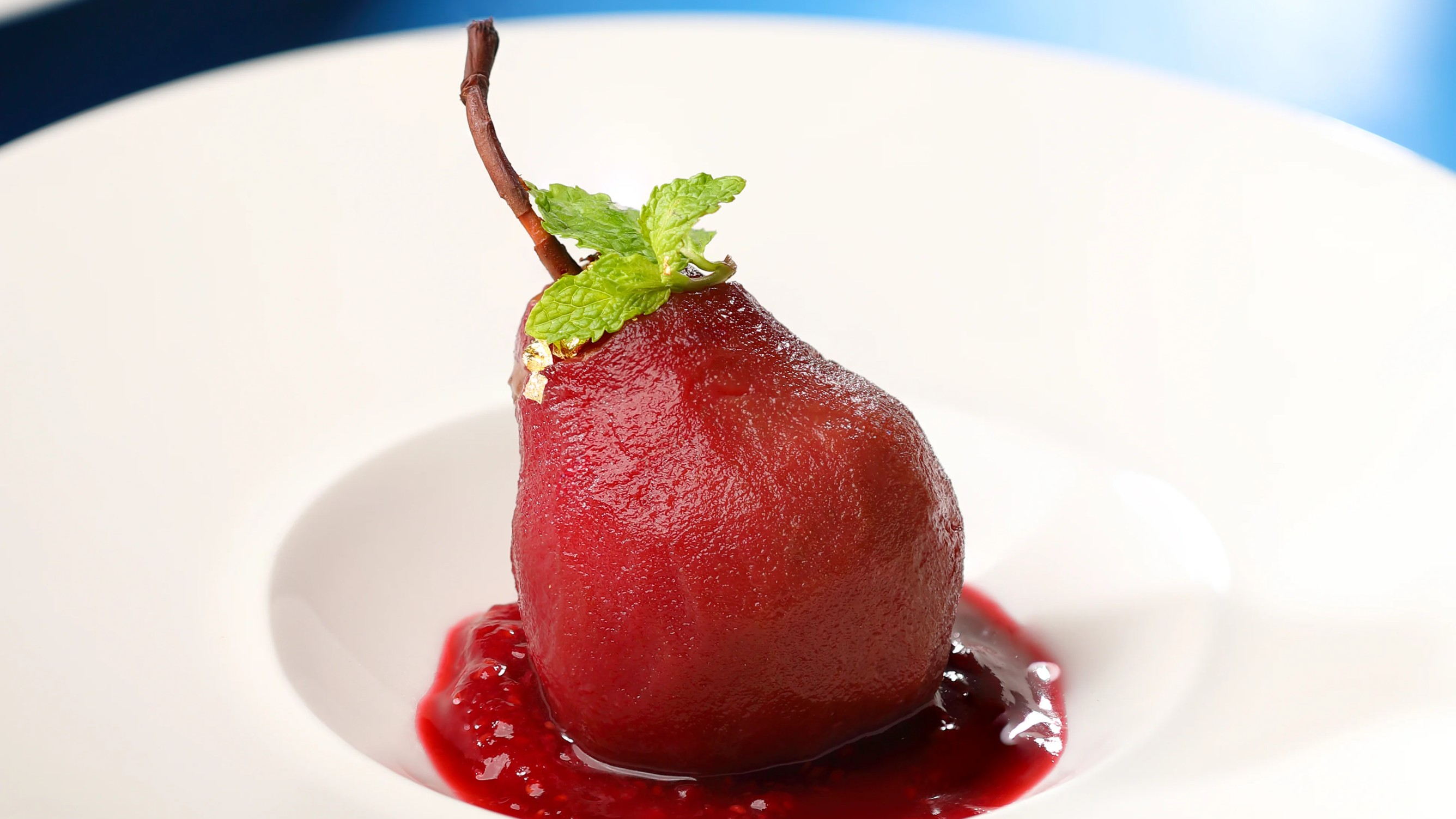 Chocolate-infused poached pear with vanilla quenelle 