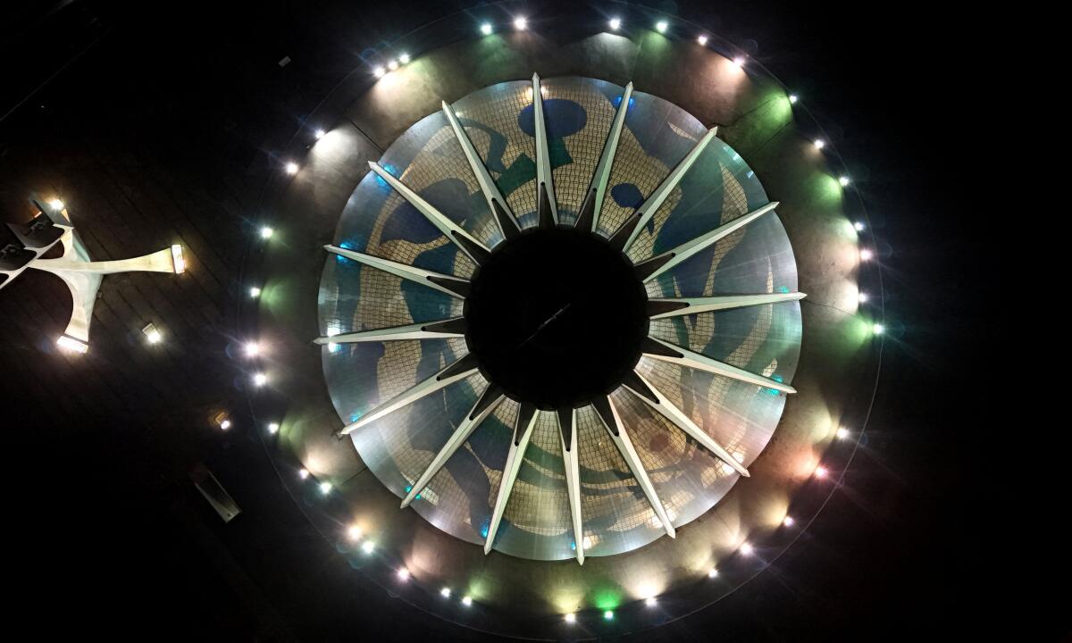 A drone view shows the Cathedral of Brasilia, designed by Brazilian architect Oscar Niemeyer, illuminated at night, in Brasilia, Brazil