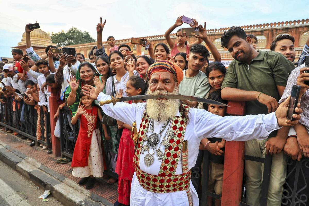 A Rajasthani folk artist during a traditional procession on the occasion of 'Teej' festival, in Jaipur