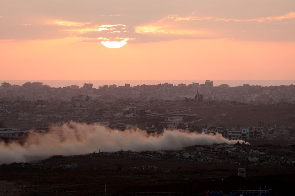Smoke rises from Gaza as the sun sets, as seen from the Israeli side of the Israel-Gaza border, July 30, 2025.