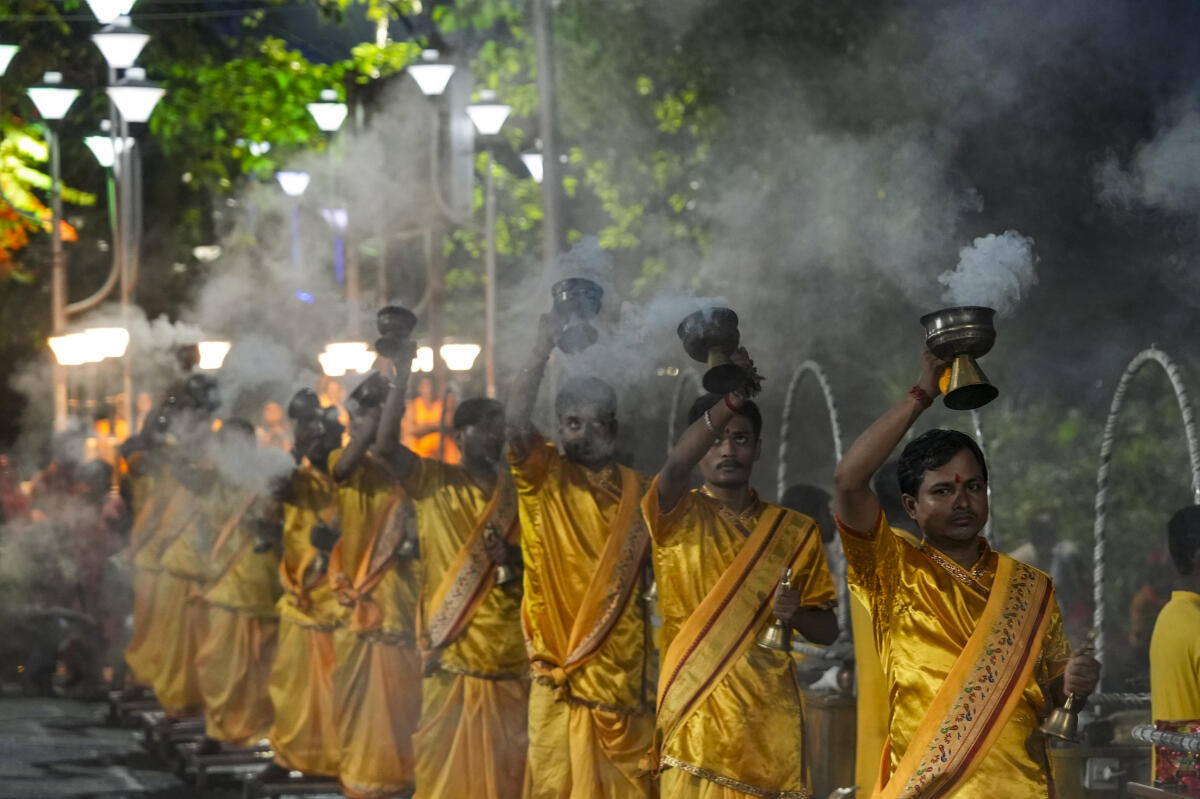 Priests perform 'Ganga Aarti' on the bank of the river, at Babughat, in Kolkata, Wednesday, July 30, 2025.