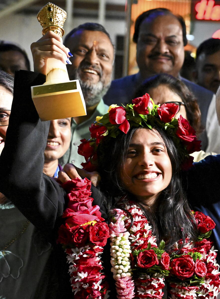 FIDE Women's World Cup 2025 champion Divya Deshmukh with her parents being welcomed upon her arrival at Nagpur airport, Wednesday, July 30, 2025.