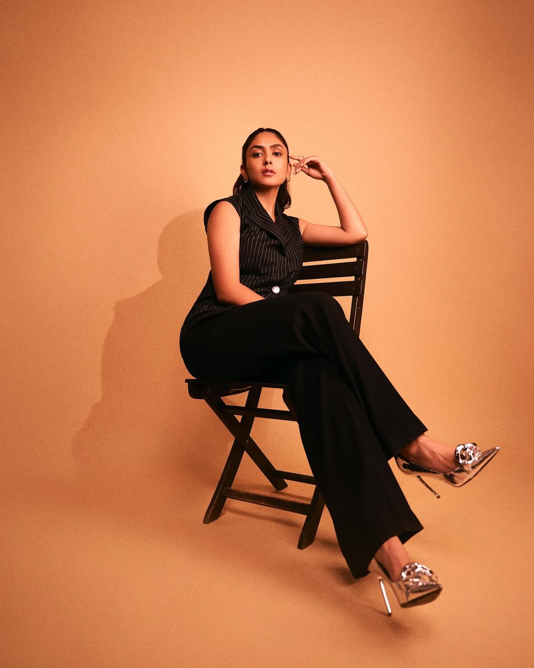Mrunal Thakur served boss-lady glamour in a sleek striped black pantsuit, perfectly paired with striking silver stilettos. With minimal accessories and maximum impact, she proved that professional dressing can still pack serious style.