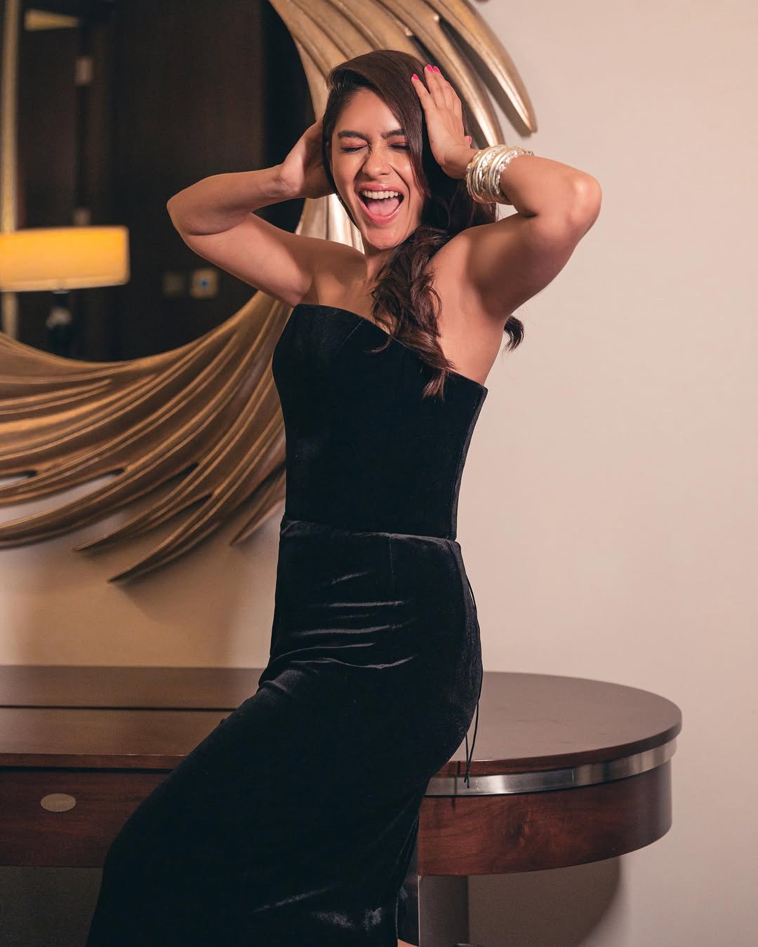 Draped in a statement black gown with a flawless fit, Mrunal Thakur served up structured elegance. Her one-sided waves and a touch of silver jewelry brought just the right edge to this fashion-forward look.