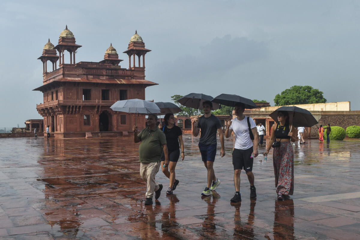Agra: Tourists visit Fatehpur Sikri amid rainfall, in Agra, Friday, Aug. 1, 2025.