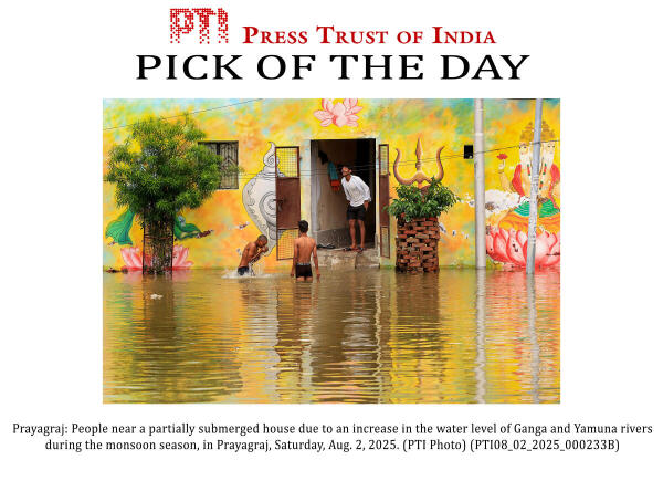 Prayagraj: People near a partially submerged house due to an increase in the water level of Ganga and Yamuna rivers during the monsoon season, in Prayagraj.