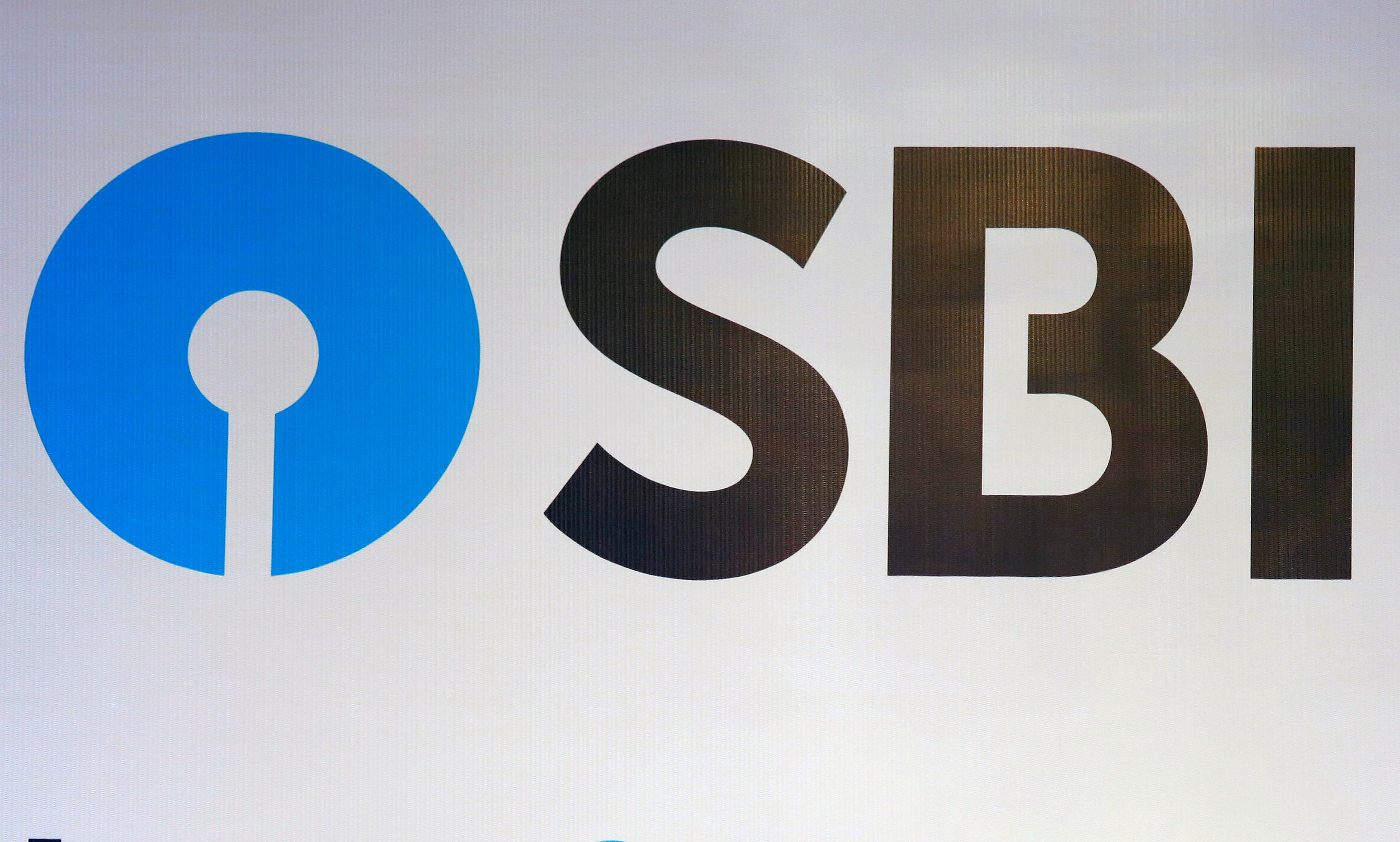 FILE PHOTO: The new logo of State Bank of India (SBI) is pictured at the podium of the venue of a news conference after the announcement of SBI