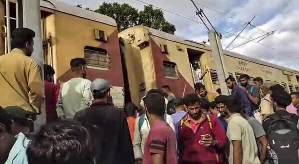 People gather at the site after several coaches of the Talaguppa–Mysuru passenger train detached, in Shivamogga district, Karnataka.