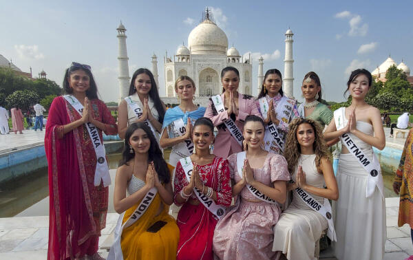 Miss Teen Earth 2025 finalists pose for a picture during their visit to the the Taj Mahal, in Agra.