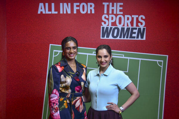 Former tennis player Sania Mirza with shuttler P.V. Sindhu poses for pictures at 'The Sports Women' event, in Mumbai.