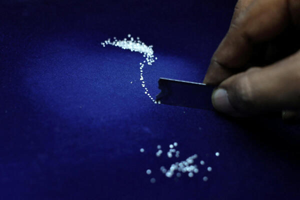 A worker sorts diamonds at a diamond processing unit in Ahmedabad, India.