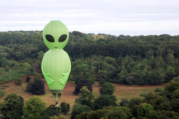 An alien-shaped hot air balloon flies during a mass launch at the annual Bristol International Balloon Fiesta, near Bristol, Britain.