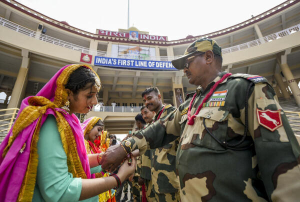Women tie 'rakhi' to Border Security Force (BSF) personnel on the occasion of the ‘Raksha Bandhan’ festival, at the Attari-Wagah border, in Amritsar district, Punjab.